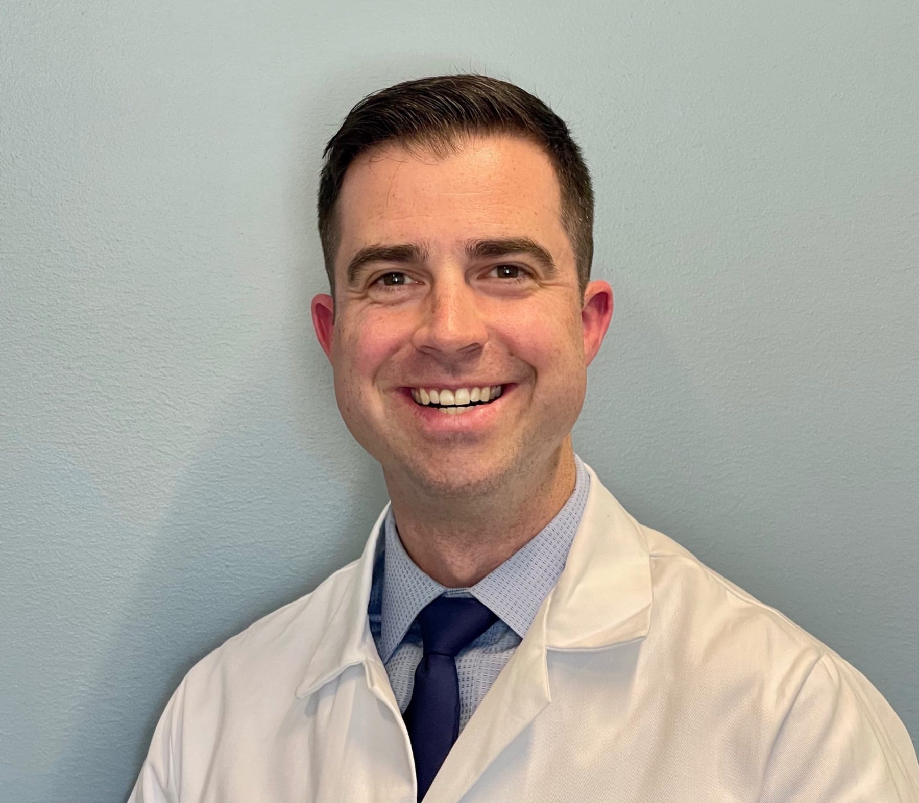 Dr. James Barnes in white coat