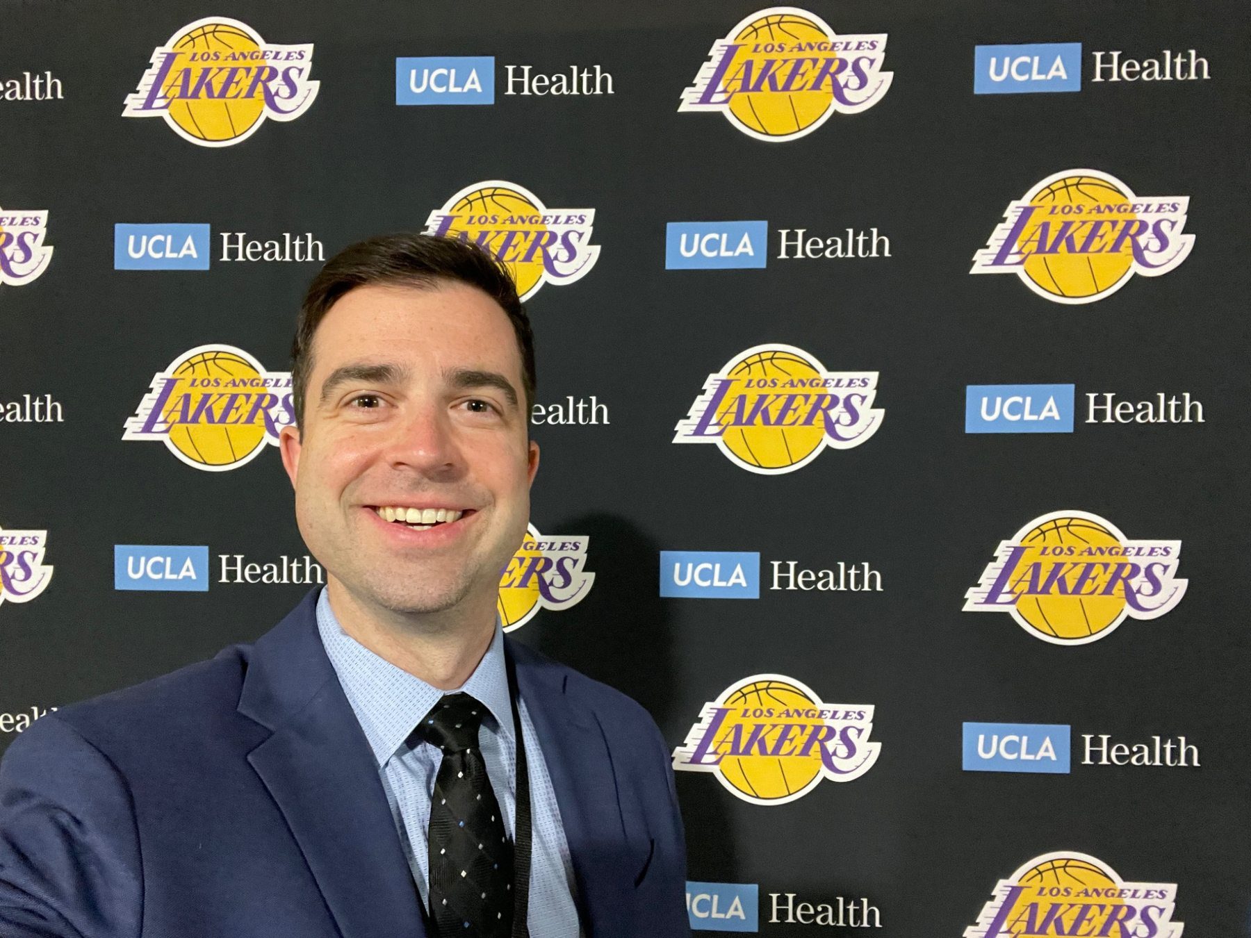 Dr. Barnes at a Los Angeles Lakers and UCLA Health backdrop