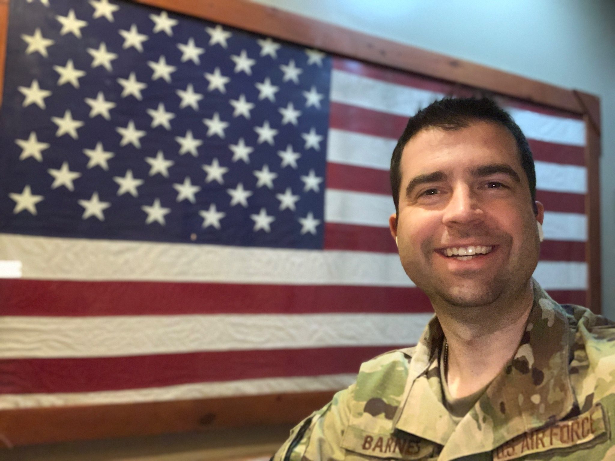 Dr. Barnes with military flag