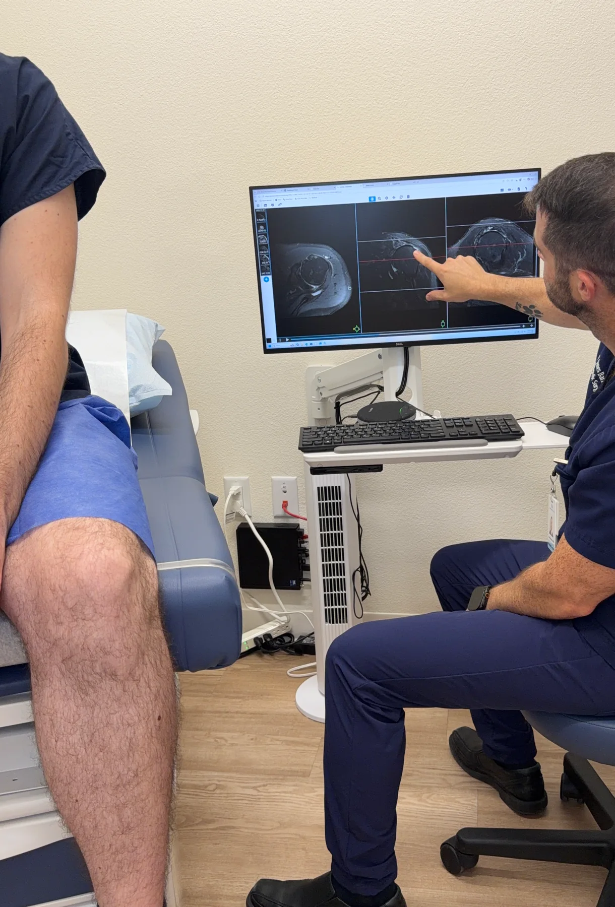 Dr. Barnes reviewing shoulder MRI images with a patient
