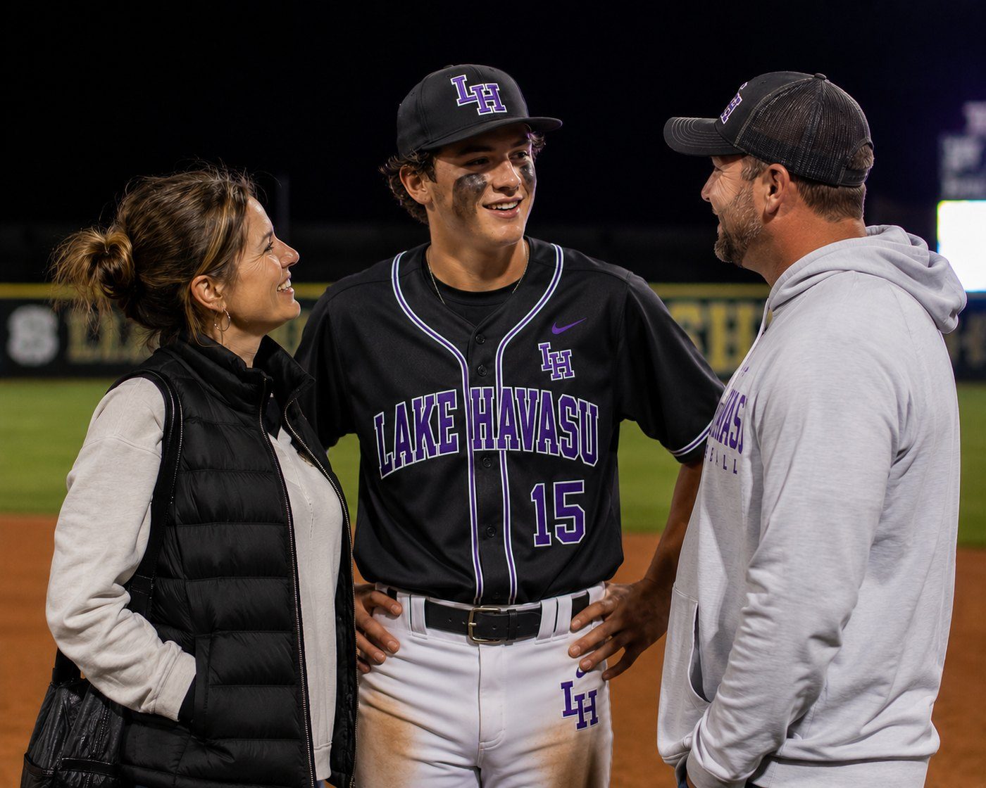 High school baseball athlete with parents after a game